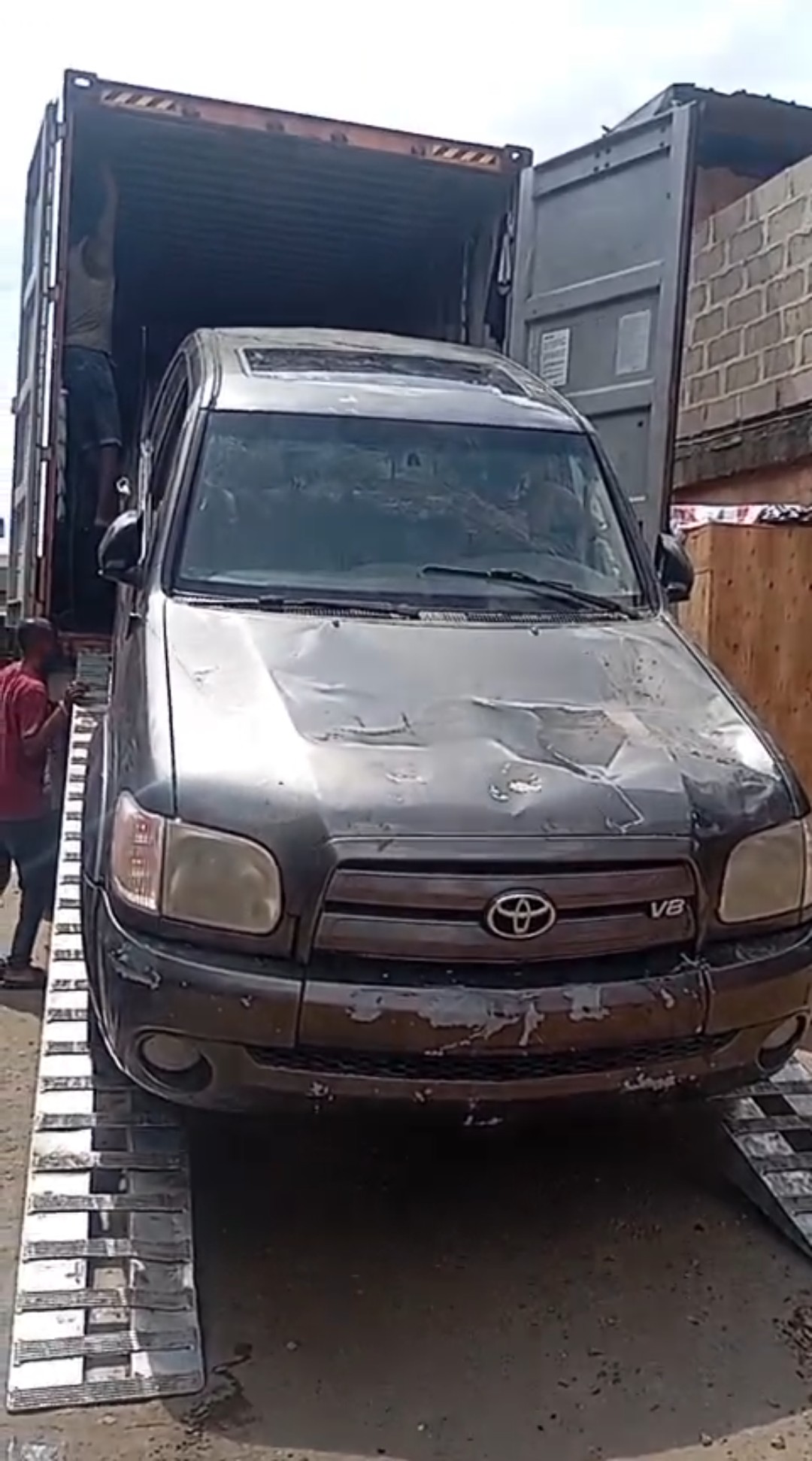 Car being offloaded from shipping container in Lagos, Nigeria